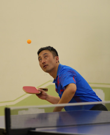 June Lim keeps his eyes on the ball when serving