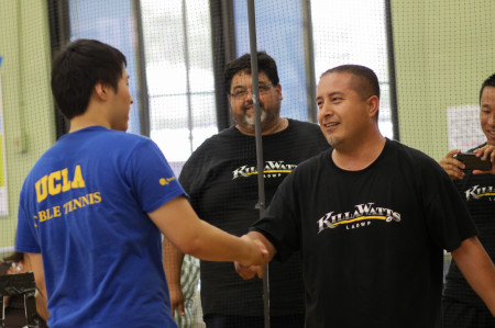 Bowen Rao and Miguel Munoz shake hands as Paul Sierra looks on