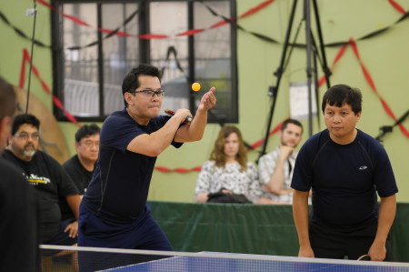 Eric Trillo serving with John Eseo in doubles