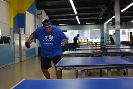 Ron Morgan is sending a fast and furious serve to Mike Schmidt in an exciting match.