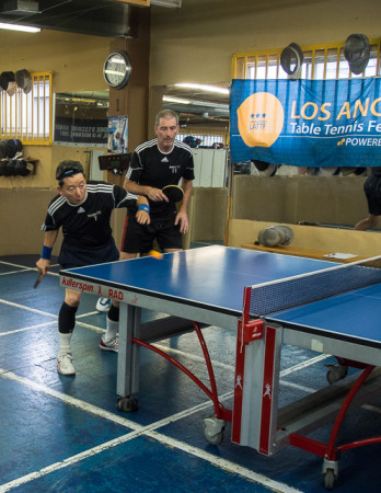 Adachi returning service in doubles.