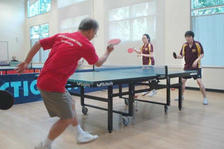 Doubles, Left to right Golden Ninja Fred Liao with back to camera in the foreground, against Gloria Deng and Franz Zhao 