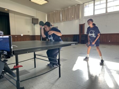 Amanda serves the ball with her doubles partner Jasmine ready for a good rally.