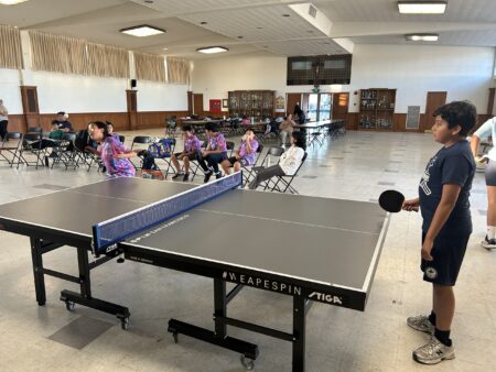 Magi Ding serves against Francisco Arias